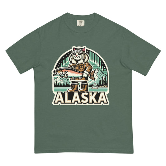 Alaska cat T-shirt in green with a graphic of a cat in winter gear holding a large fish in Alaska scenery