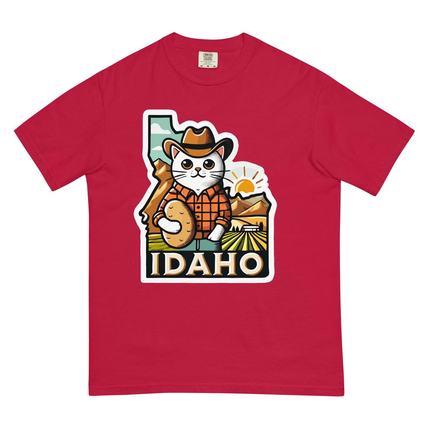 Red Idaho cat shirt featuring a cartoon cat in a cowboy hat holding a potato with Idaho landscape background