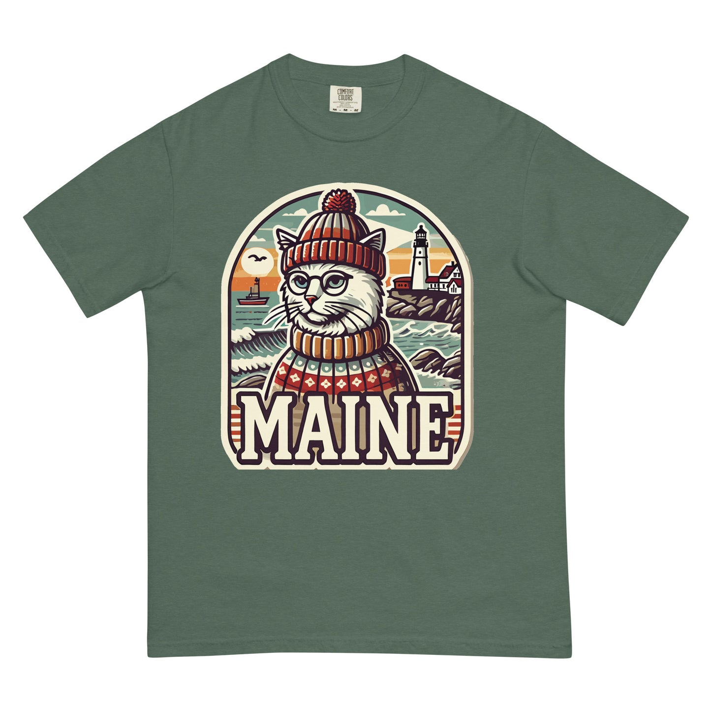 Meowrica green Maine cat t-shirt featuring a cat in a sweater and beanie with a lighthouse background