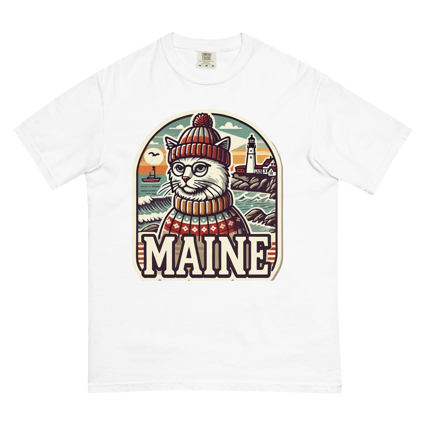White Maine cat t-shirt featuring a cat in a knit hat and sweater with a Maine coastal background