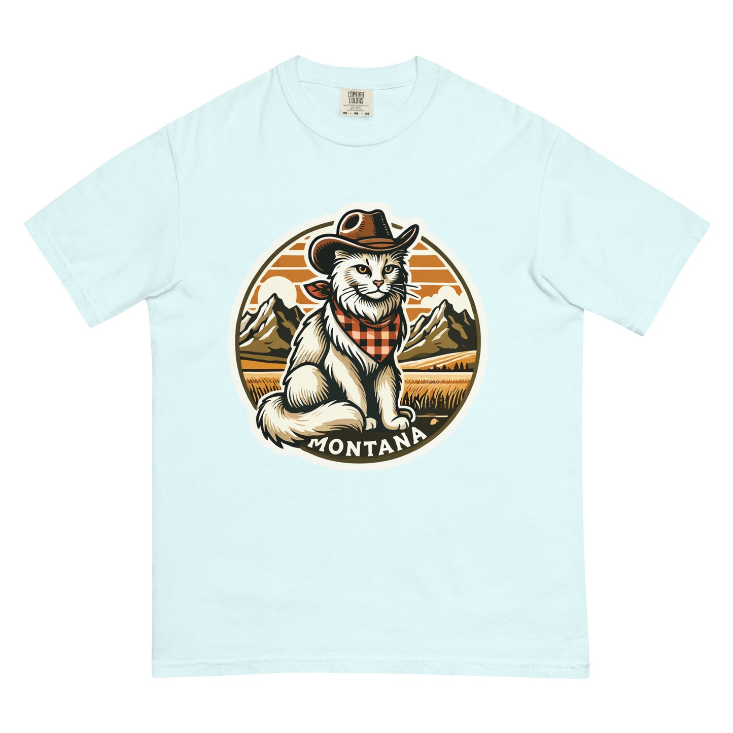 Light blue Montana cat t-shirt featuring a cowboy cat with mountains and sunset background