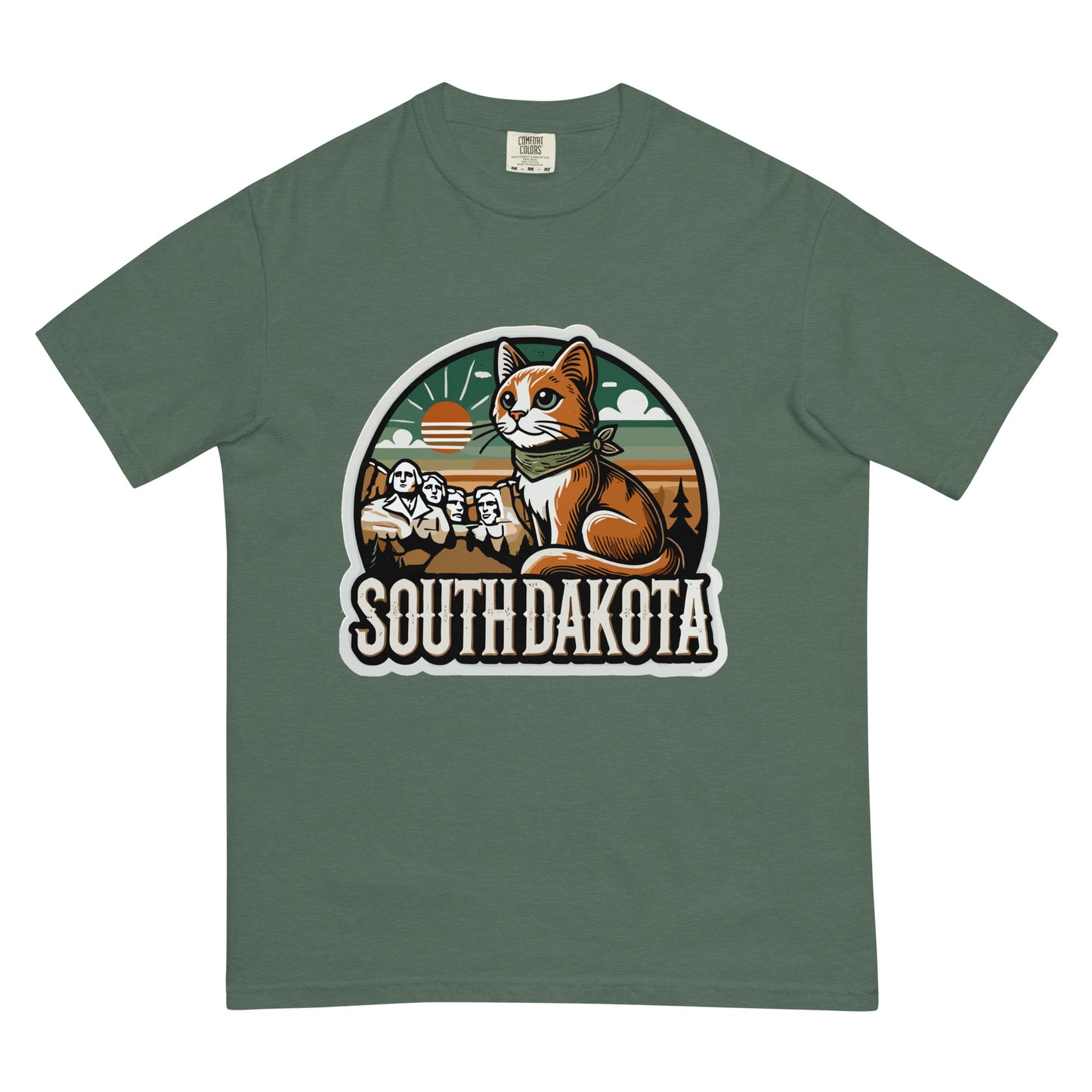 meowrica South Dakota cat t shirt with graphic of a cat and Mount Rushmore on green fabric