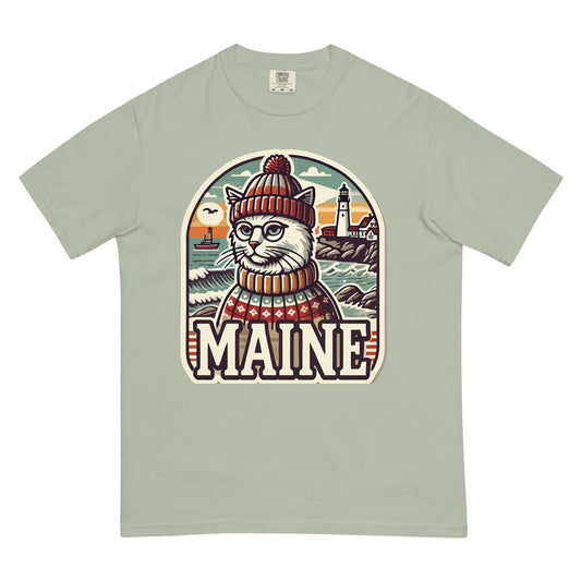 Light green Maine cat t-shirt featuring a cat in a hat and sweater with a lighthouse background