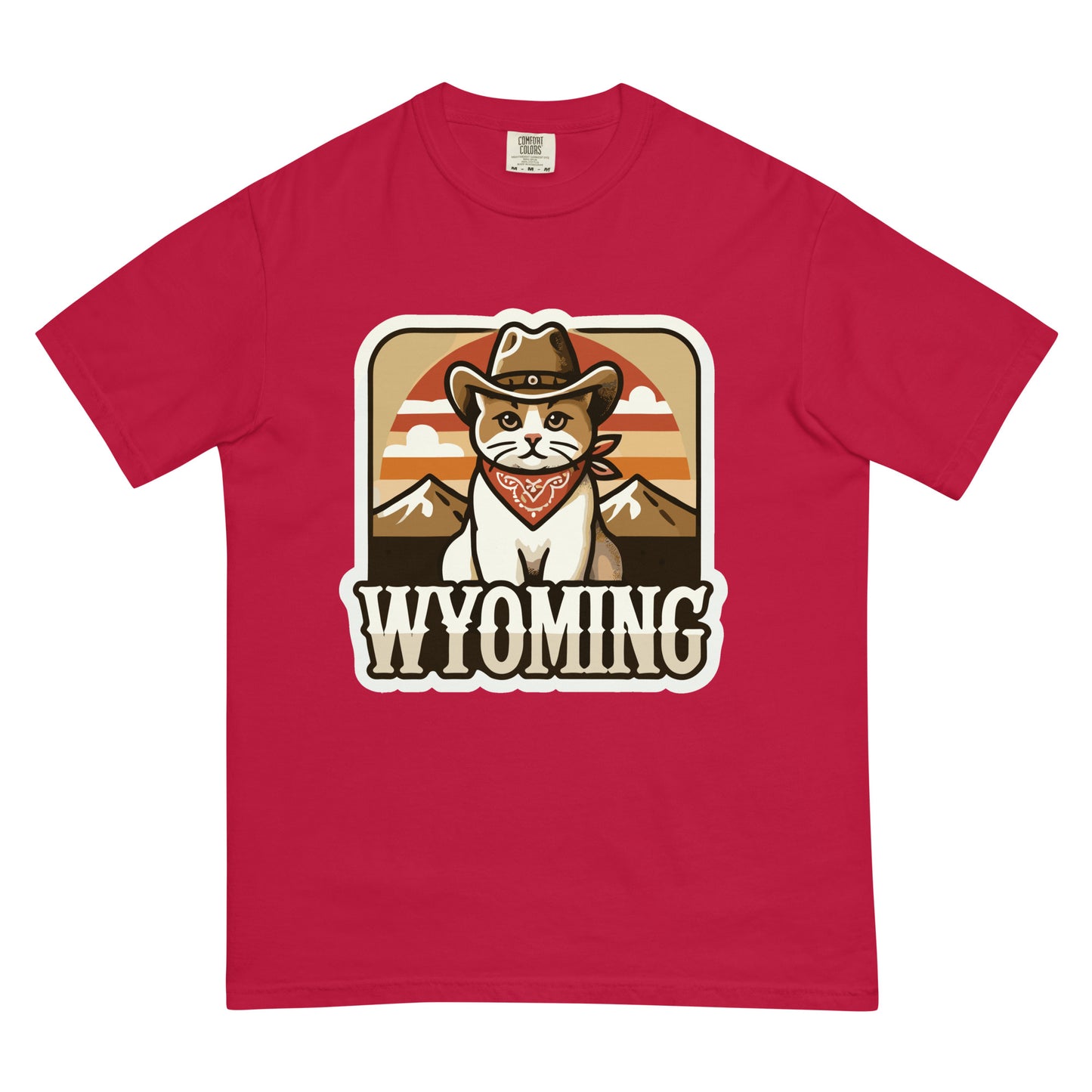 Red Wyoming cat t-shirt featuring a cat wearing a cowboy hat and bandana with mountain background